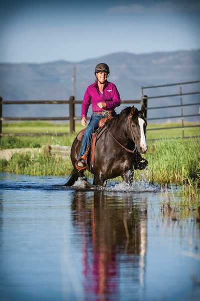 Julie riding Dually in the pond, Cosequin shirt on.