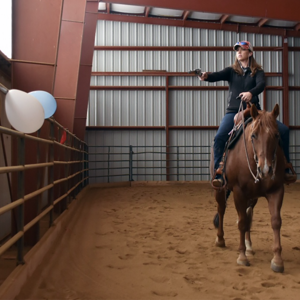 Melissa working with Eddie to learn mounted shooting.