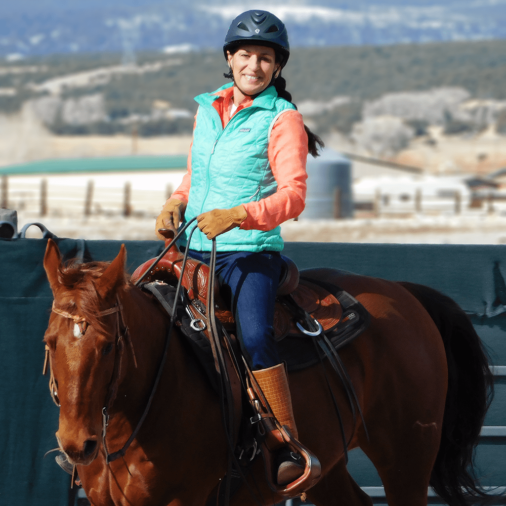 Julie riding Annie in the arena