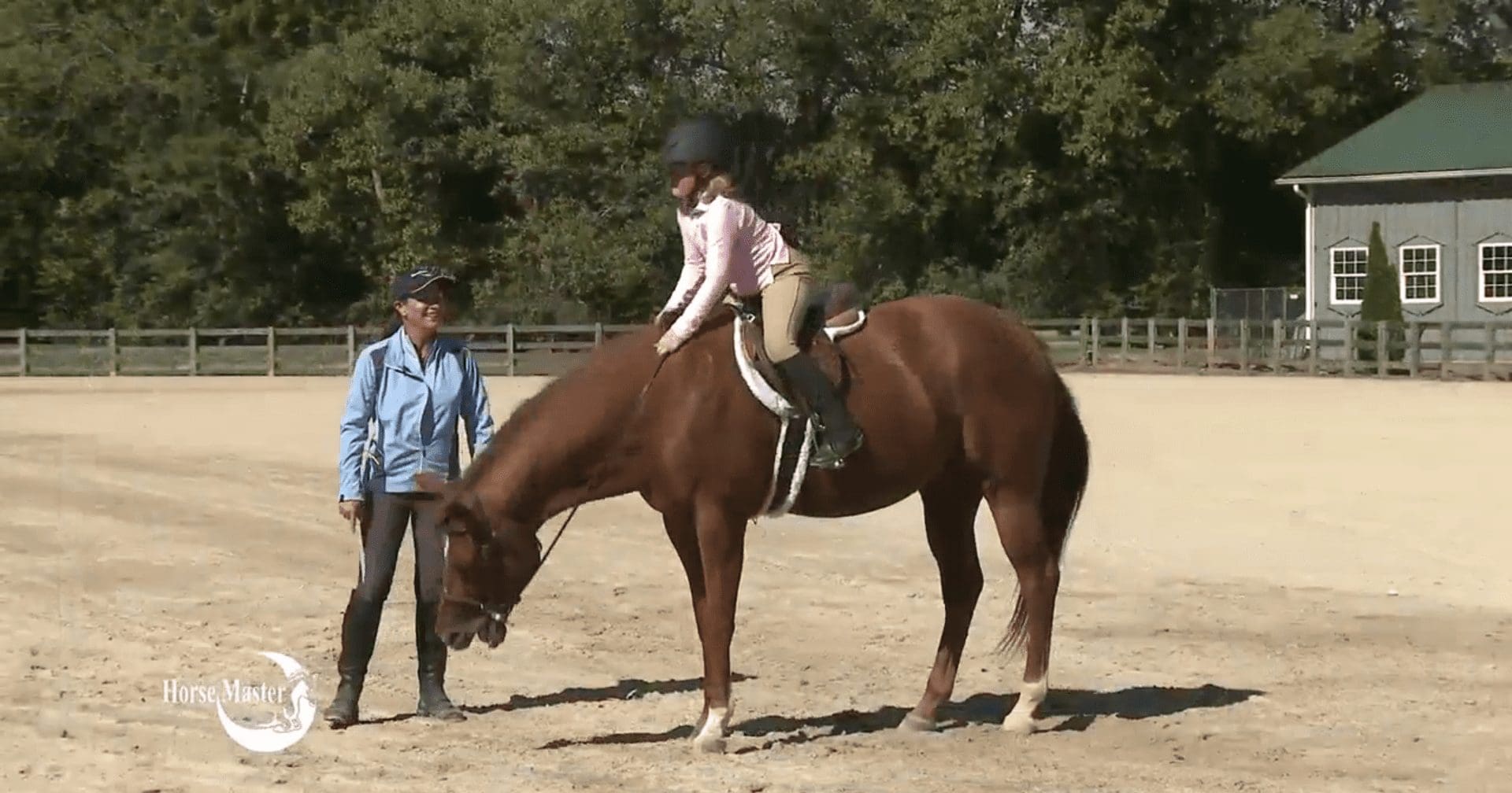 Abby on Skippy with Julie standing beside them.