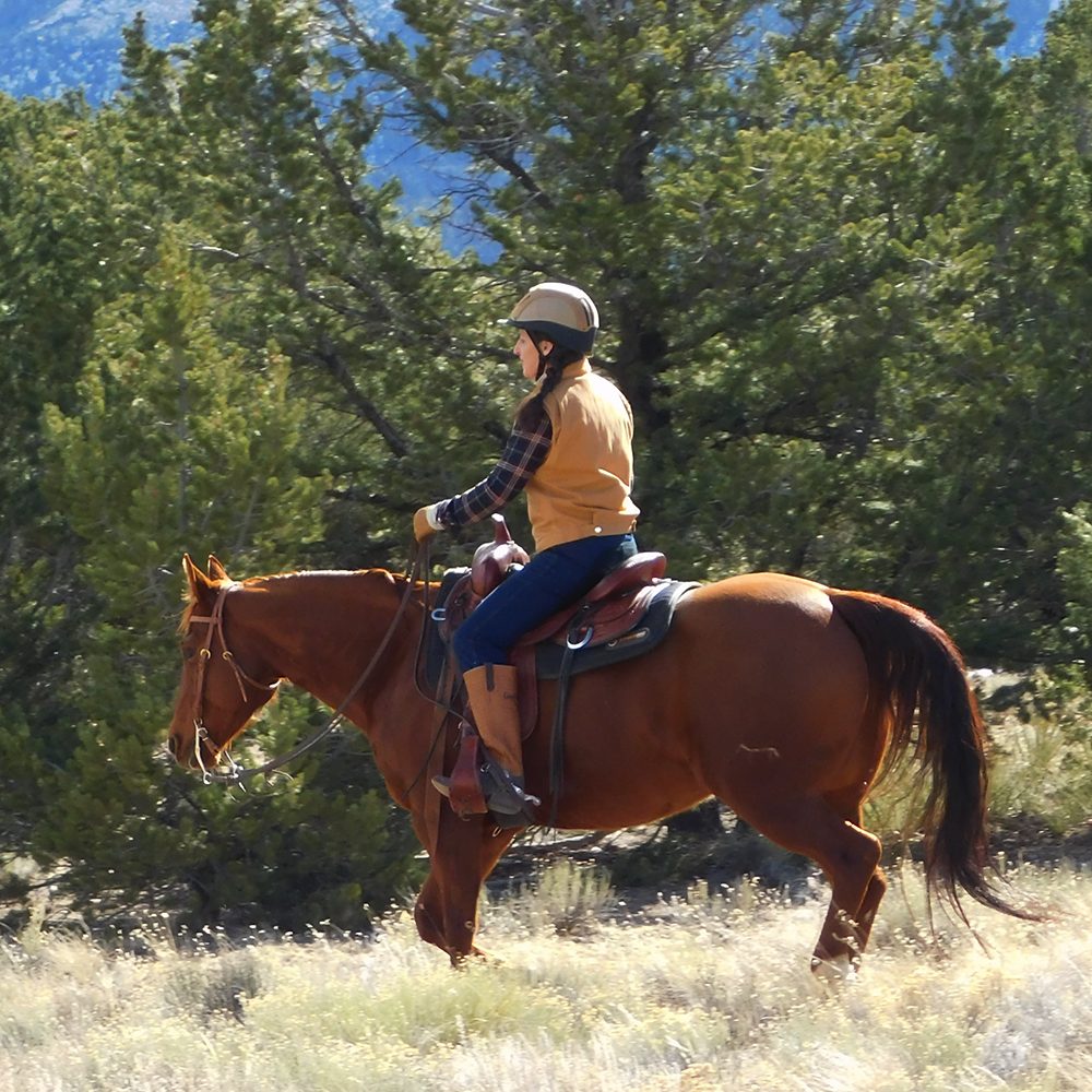 Julie riding in the mountains.